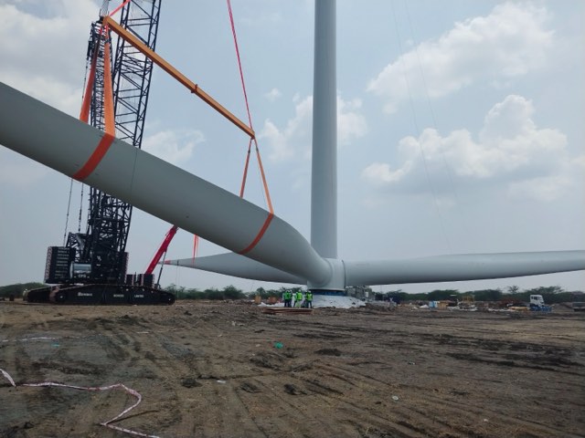 Crew erecting a wind turbine tower section