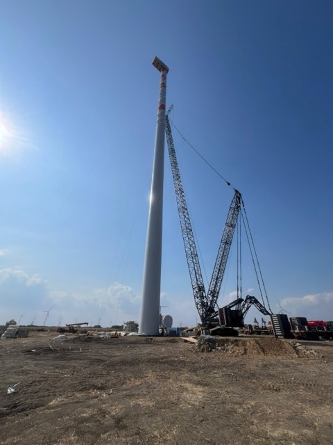 Crane assembling a wind turbine tower