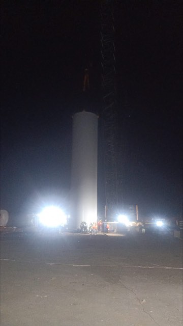 Crane lifting turbine components at the site