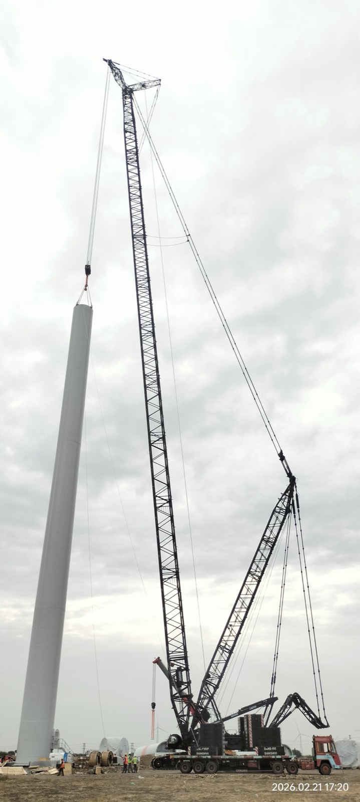 Crane lifting a wind turbine tower section into place