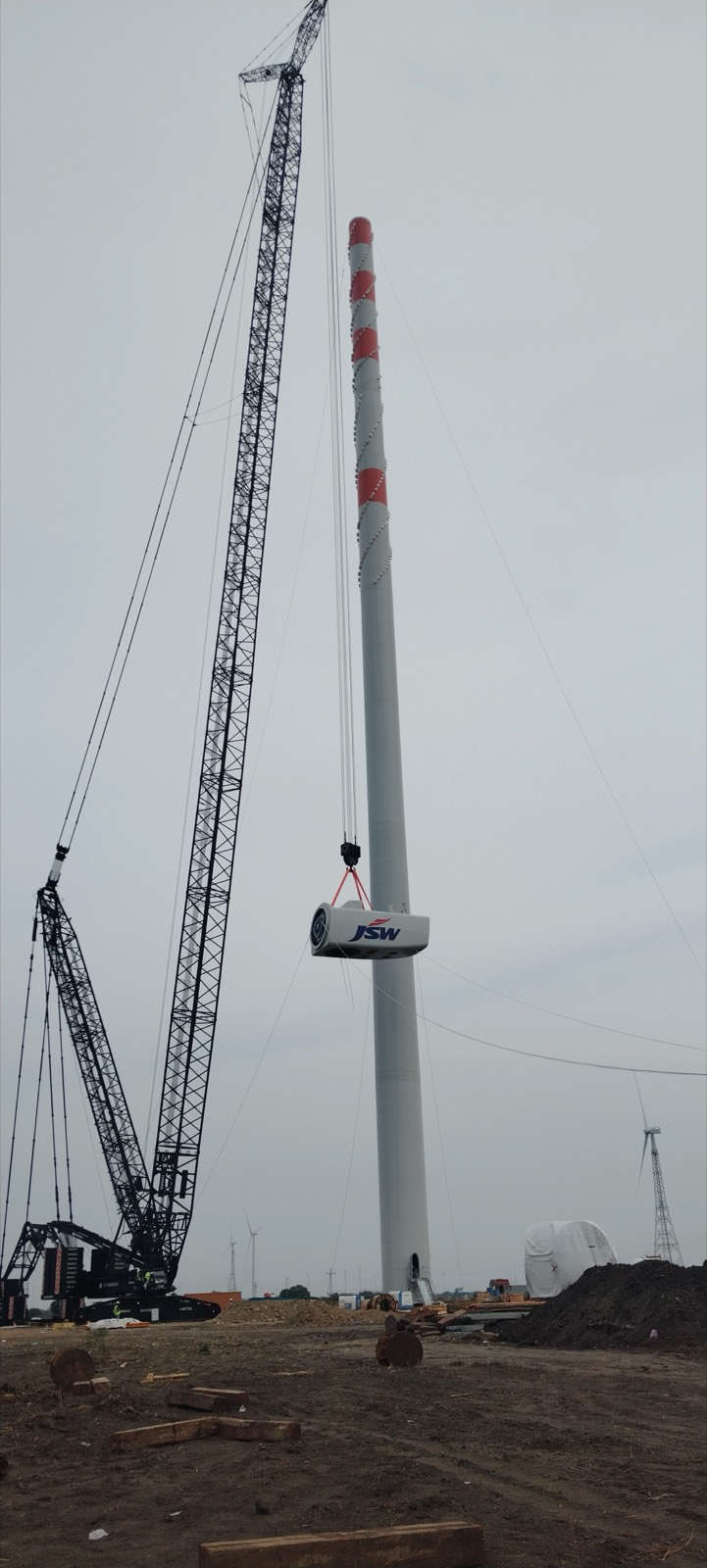 Crane lifting a turbine nacelle into position
